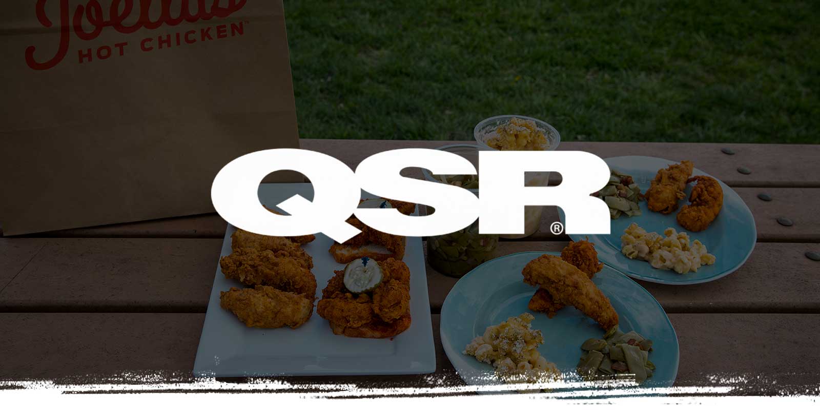 QSR logo on picnic meal background