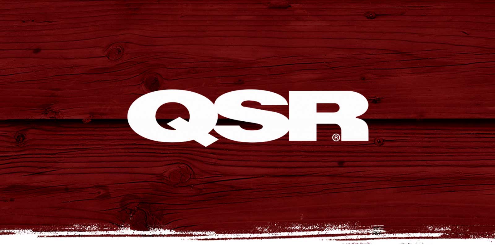 QSR logo on red weathered wood background